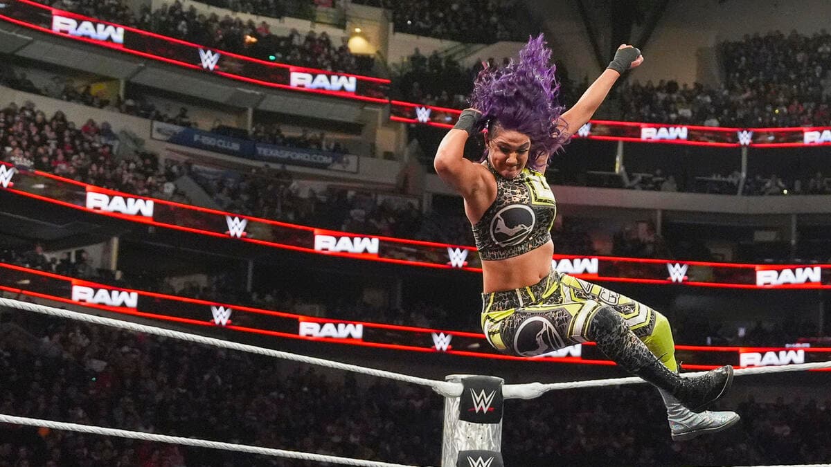 Bayley in mid-air about to hit a Flying Elbow