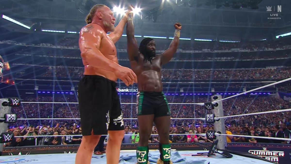Brock Lesnar raising Oba Femi's arm 