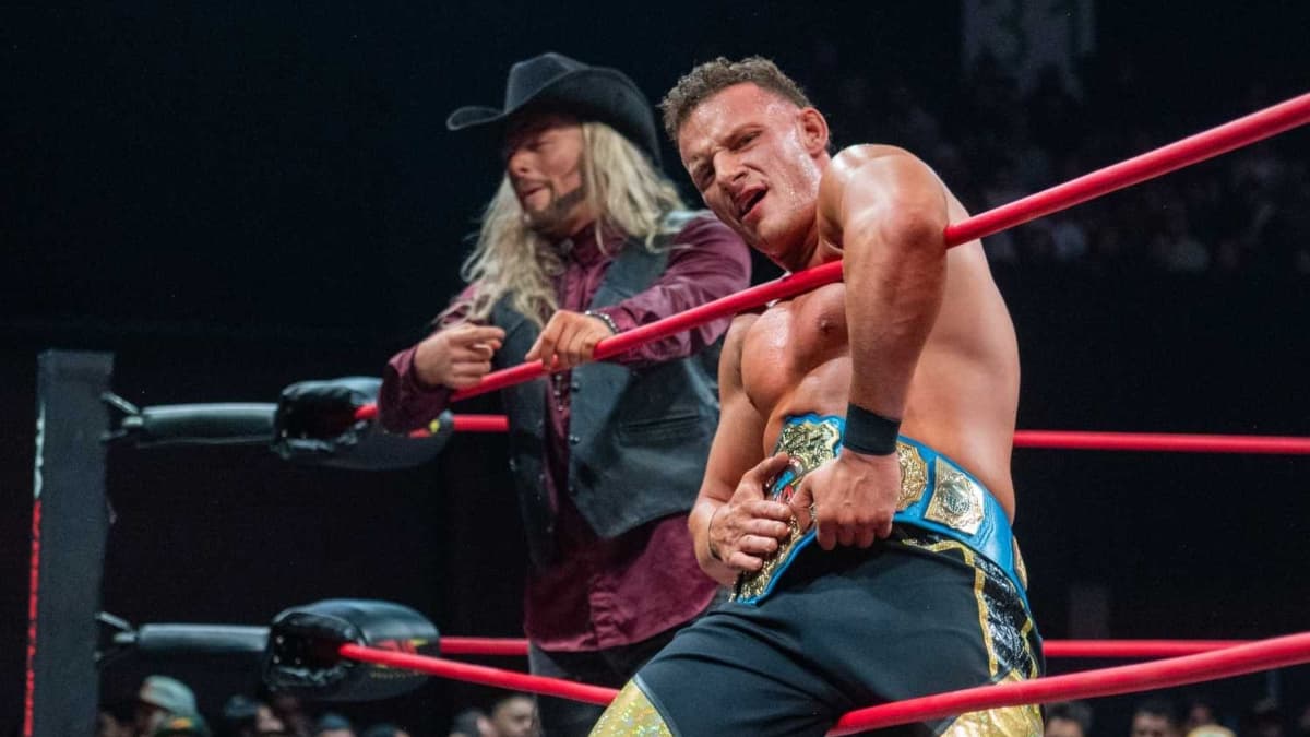 Channing "Stacks" Lorenzo holding the TNA International Title with Lexis King stood behind him