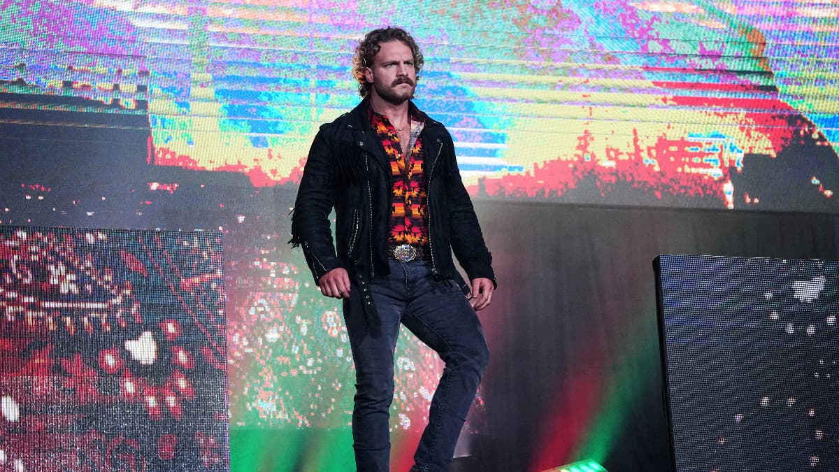 Hangman Page in jeans, shirt, and a jacket, walks down the entrance steps in Arena Mexico