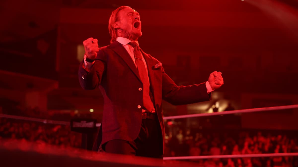 Ilja Dragunov cheering while bathed in red light