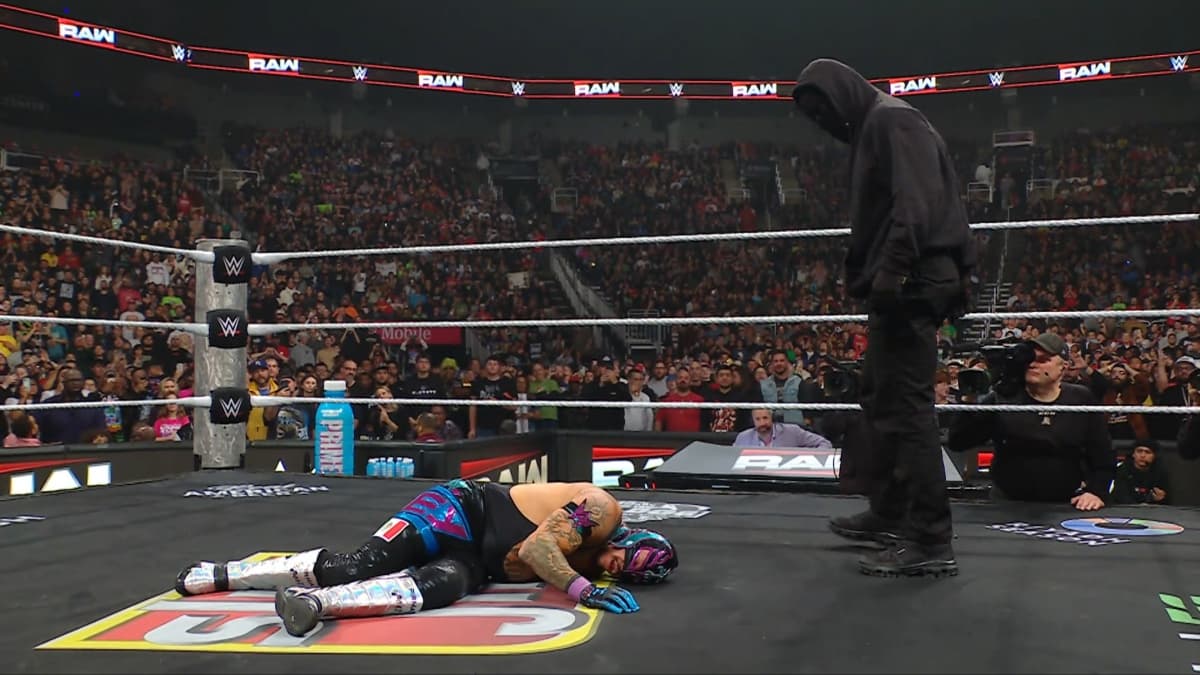 Masked Man standing over Rey Mysterio on December 2025 episode of WWE Raw