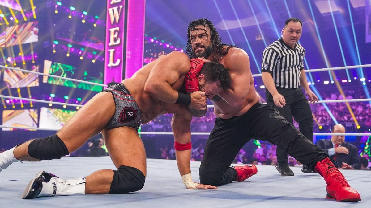 Roman Reigns with LA Knight in a headlock at WWE Crown Jewel 2023