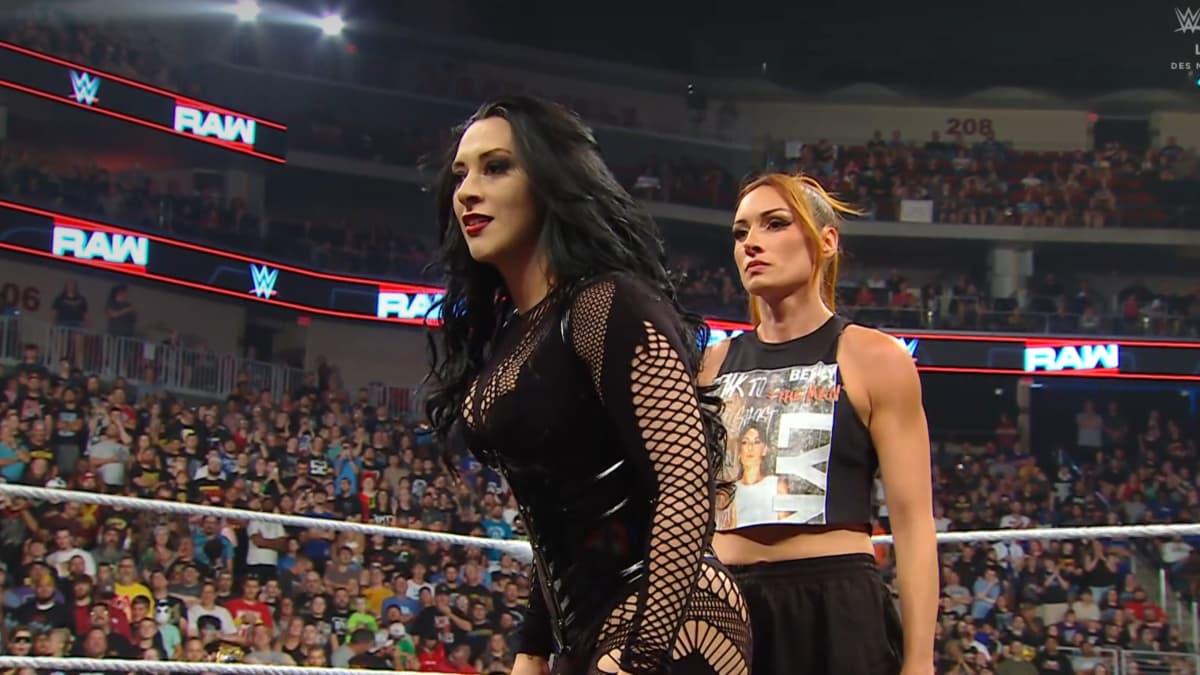 Stephanie Vaquer with Becky Lynch stood behind her in a WWE ring