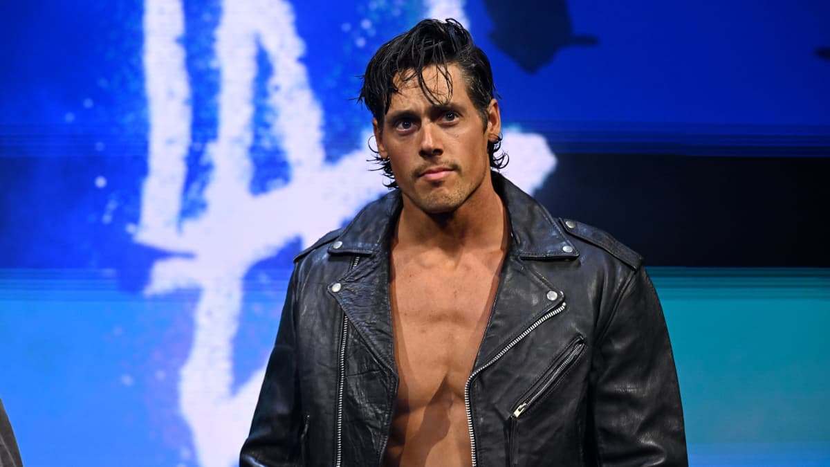 Steven Borden in a leather jacket walks toward a wrestling ring