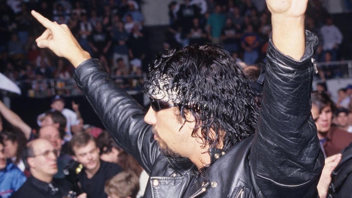 Syxx in WCW with his arms up 