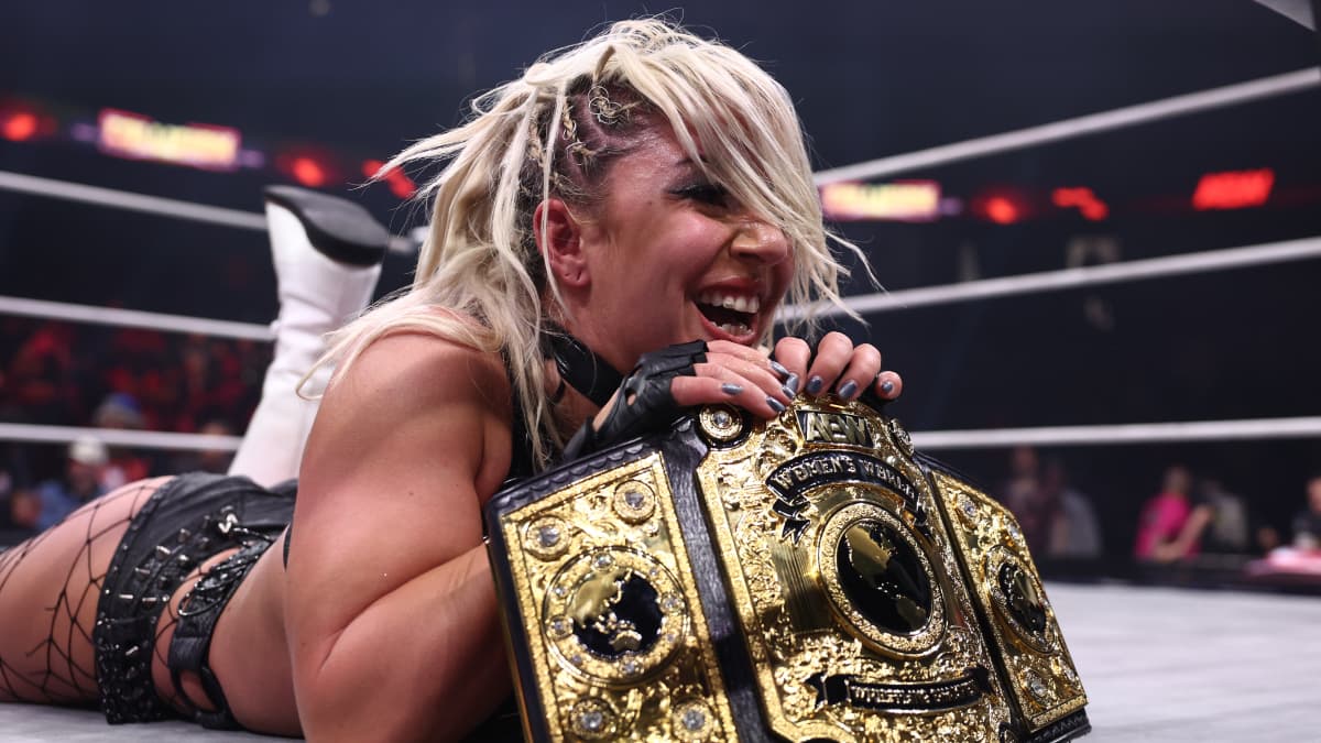 Thekla holding the AEW Women's World Title while lying down