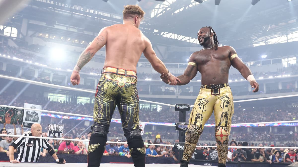 Will Ospreay shakes Swerve Strickland's hand in a wrestling ring in front of an audience