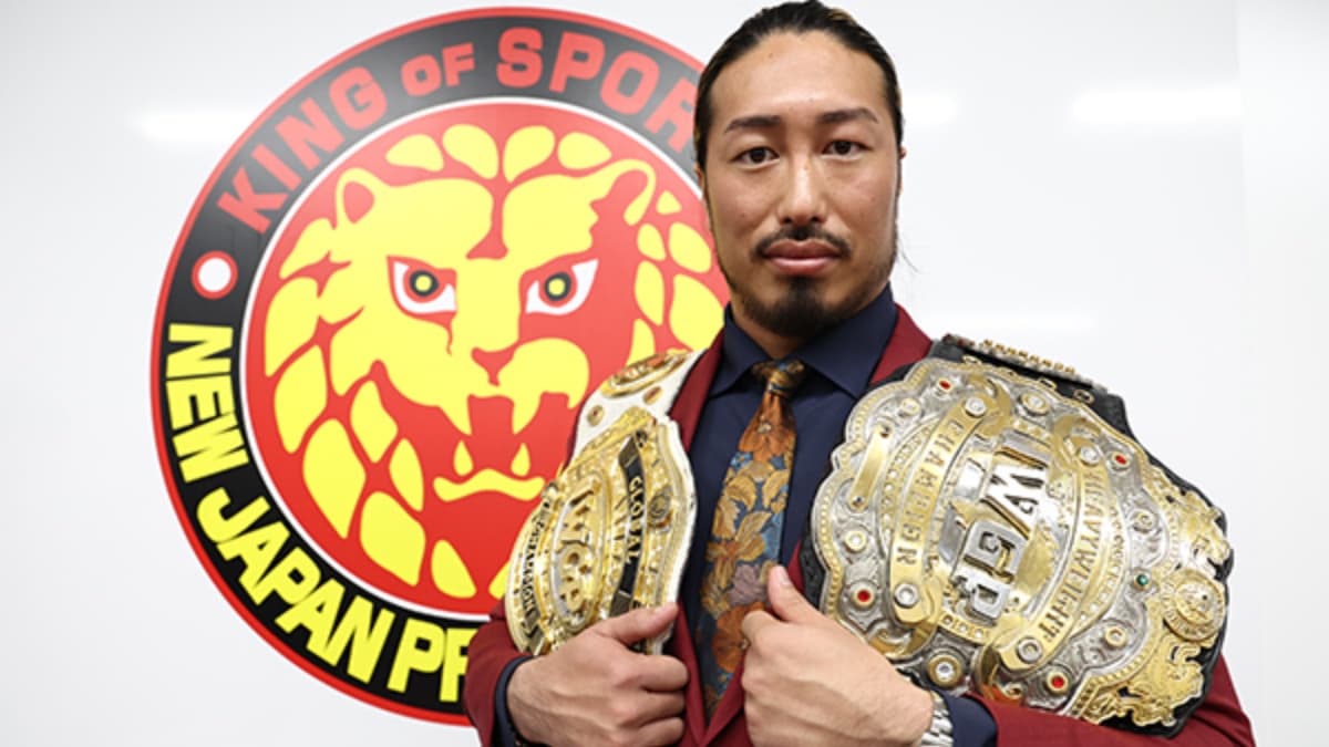 Yota Tsuji with the IWGP Heavyweight Title and IWGP Global Heavyweight Title around his shoulders