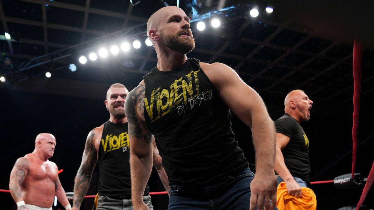 Alan Angels looks to the crowd with Violent by Design members behind him.