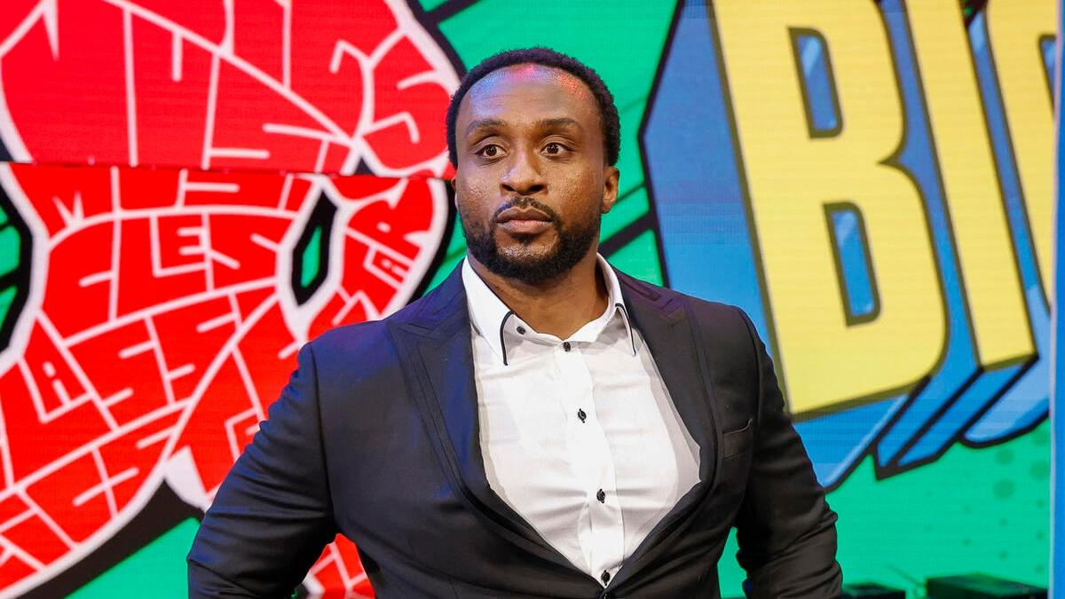Big E makes his entrance wearing a suit jacket and shirt during an episode of WWE Raw in December 2024