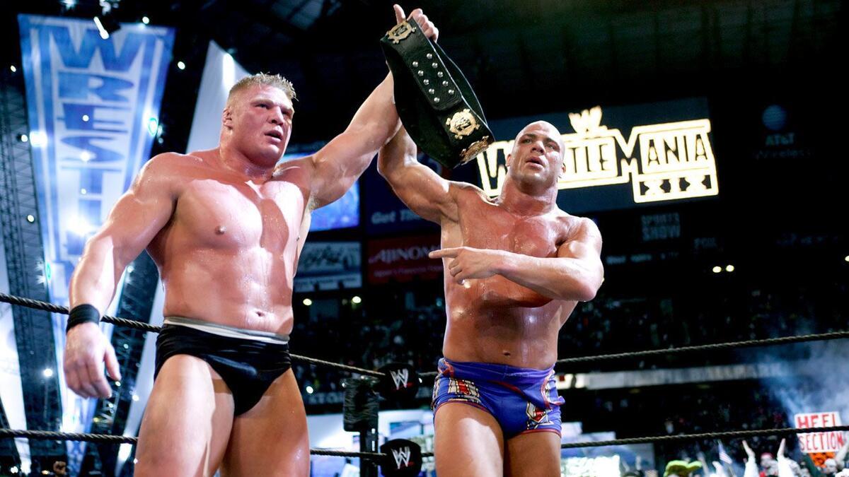 Kurt Angle raising a groggy Brock Lesnar's arm at WWE WrestleMania XIX