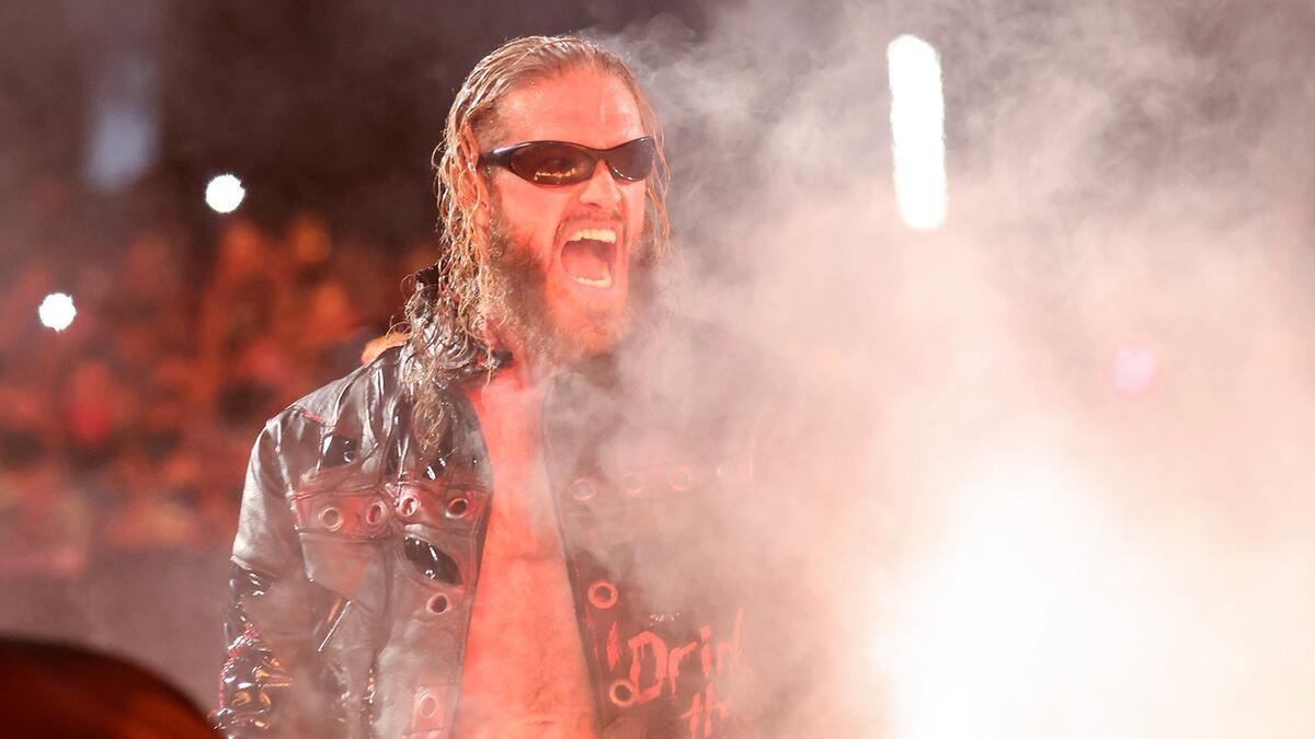 Edge wearing sunglasses laughing maniacally at smoke rolls in at WWE SummerSlam 2021