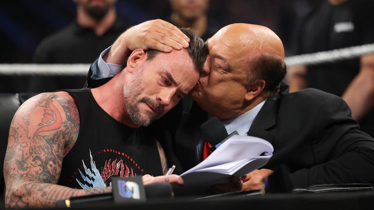 An emotional CM Punk being kissed on the head by Paul Heyman