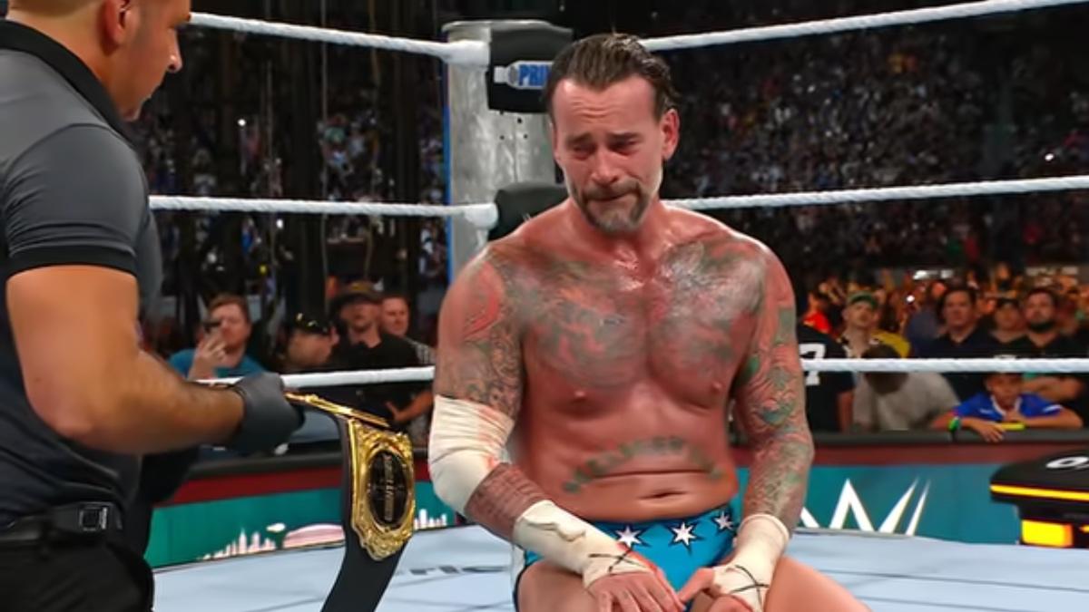 CM Punk crying while looking at the World Heavyweight Title