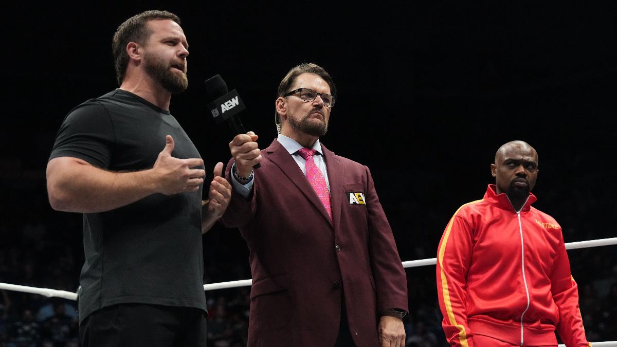 Tony Schiavone interviews Cash Wheeler in an AEW ring as Stokely Hathaway watches on