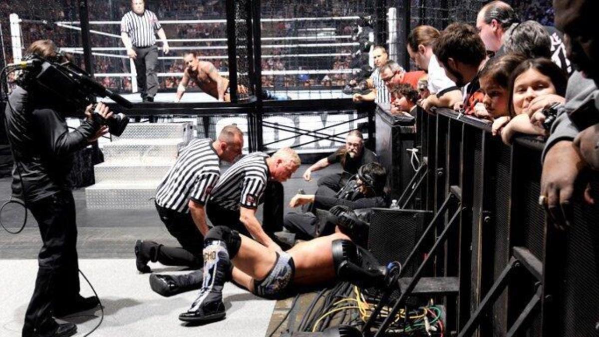 Chris Jericho lay on the outside as WWE referees surround him at WWE Elimination Chamber 2012