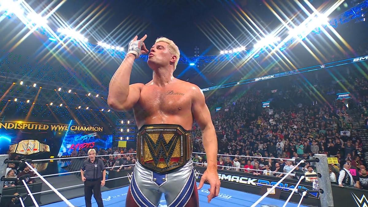 Cody Rhodes doing the bullet club salute while stood on the top turnbuckle in WWE