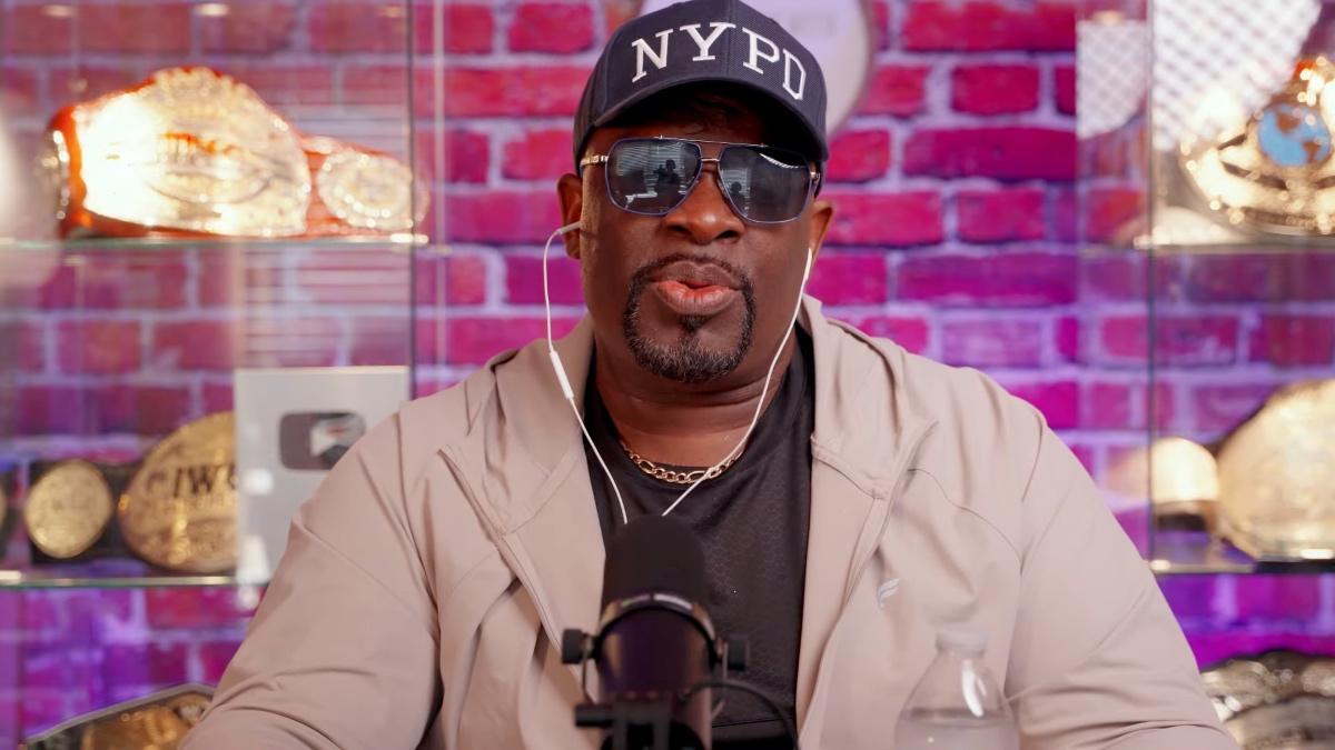 D-Von Dudley pursing his lips together while wearing an NYPD hat