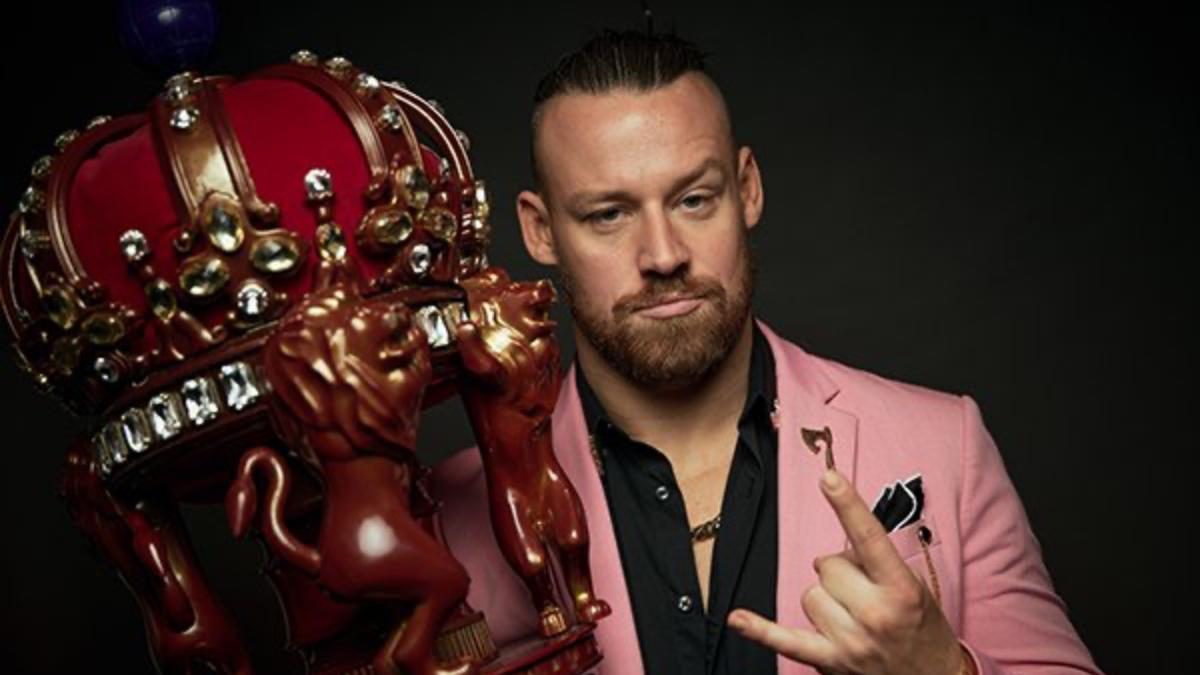 David Finlay in a pink suit holding the New Japan Cup