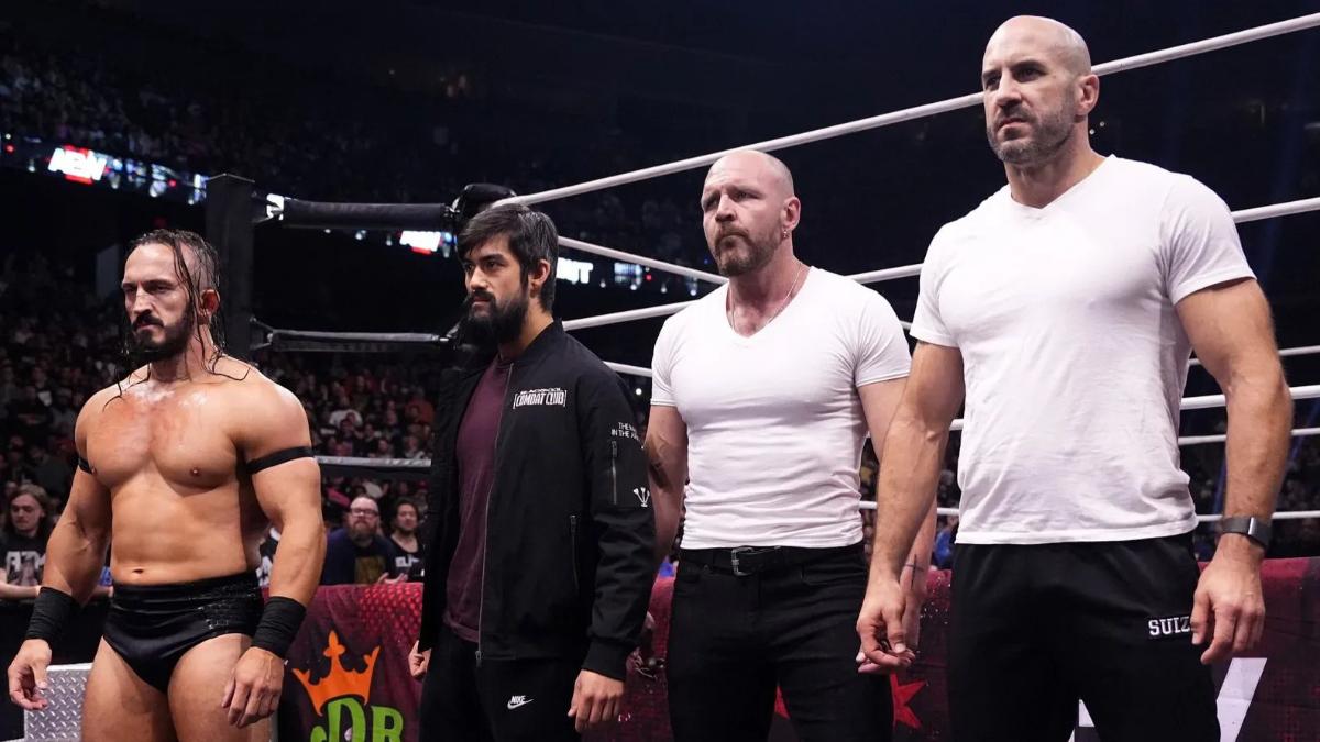 PAC, Wheeler Yuta, Jon Moxley, and Claudio Castagnoli guard a wrestling ring whilst looking off camera.