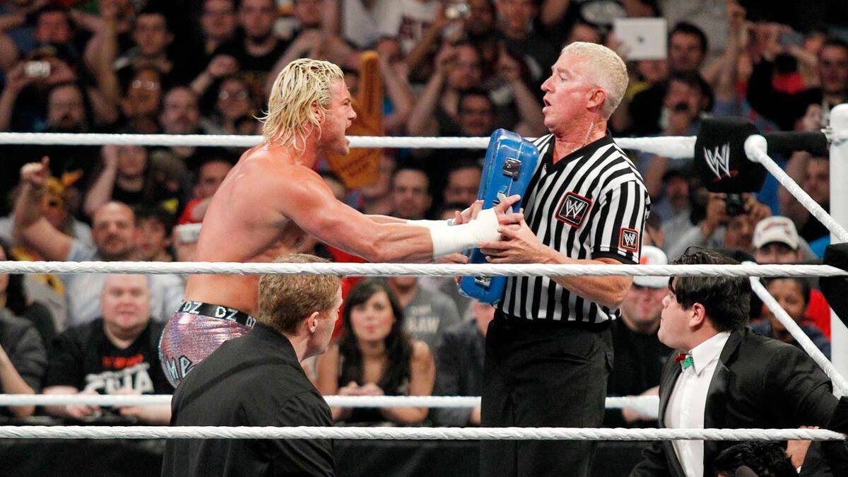 Dolph Ziggler handing his Money in the Bank briefcase to WWE referee Scott Armstrong