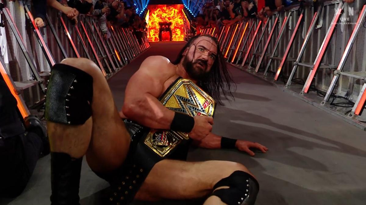 Drew McIntyre holding the Undisputed WWE Title while crawling up an entrance ramp