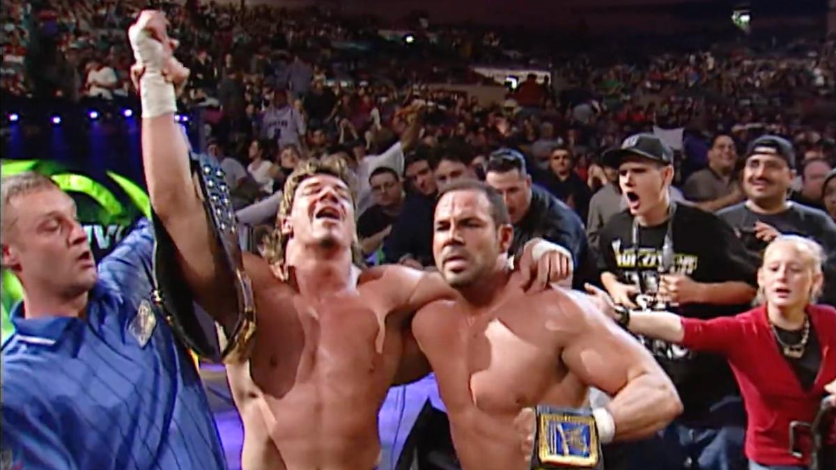 Eddie Guerrero and Chavo Guerrero celebrating with the WWE Tag Team Titles