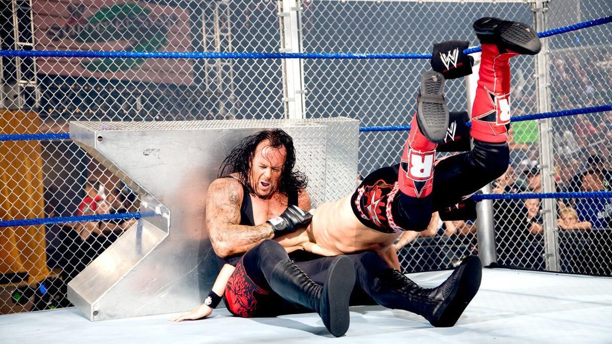 Edge spearing The Undertaker into steel steps