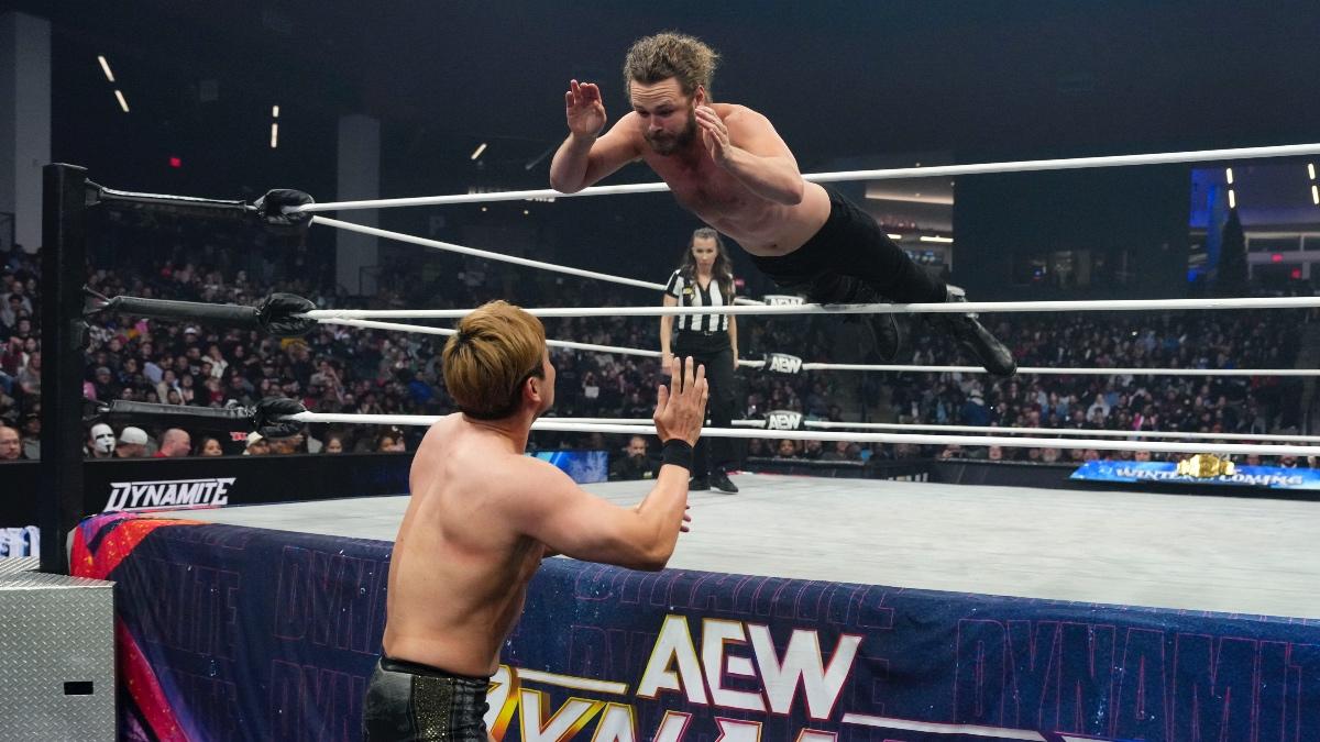 Jack Perry hitting a suicide dive to Kazuchika Okada