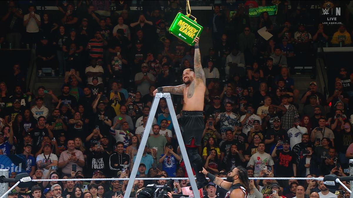 Jacob Fatu grabbing Solo Sikoa's foot while he climbs the ladder at WWE Money in the Bank 2025