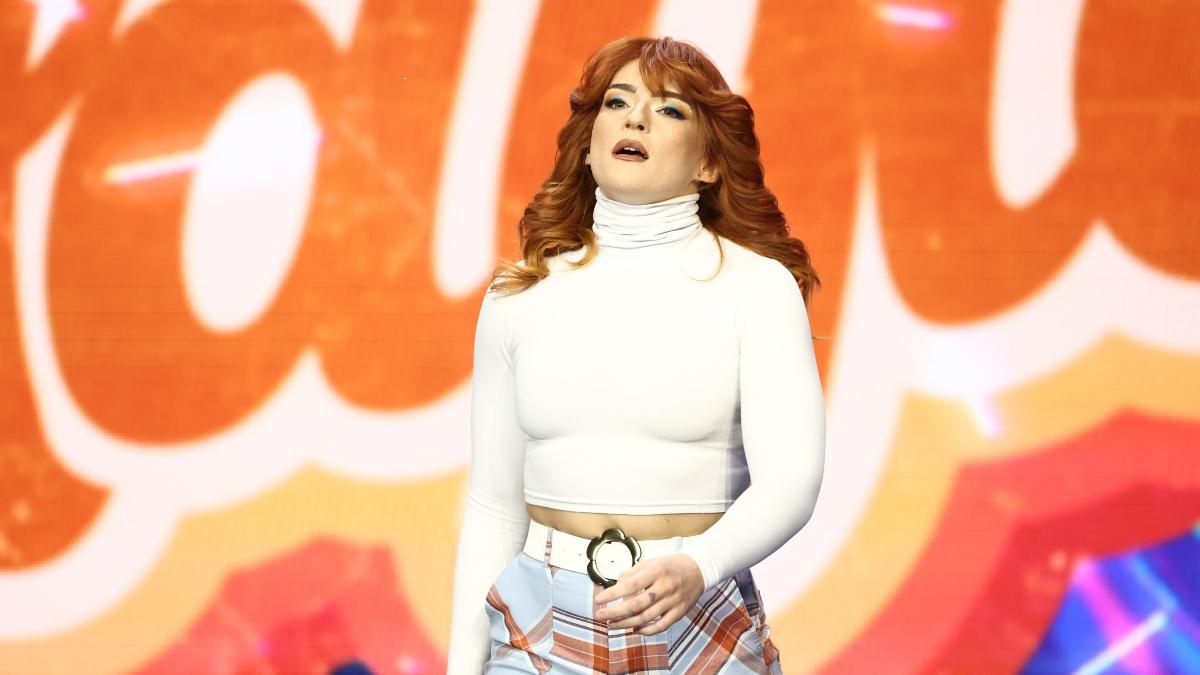 Jamie Hayter in a white turtleneck jumper