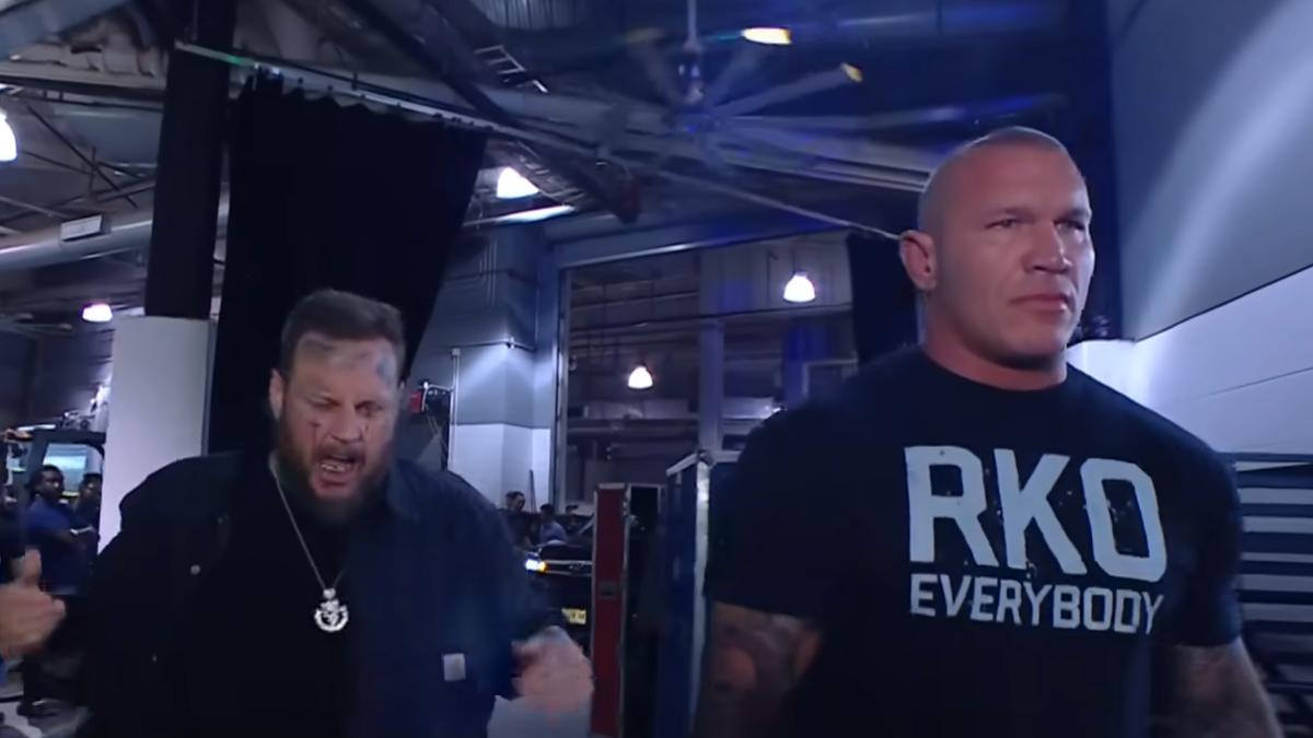 Jelly Roll and Randy Orton backstage at a WWE event. Jelly Roll is yelling.