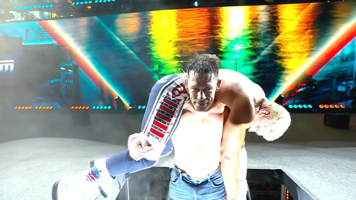 John Cena holding Cody Rhodes in the Attitude Adjustment position while being raised through the stage at SummerSlam