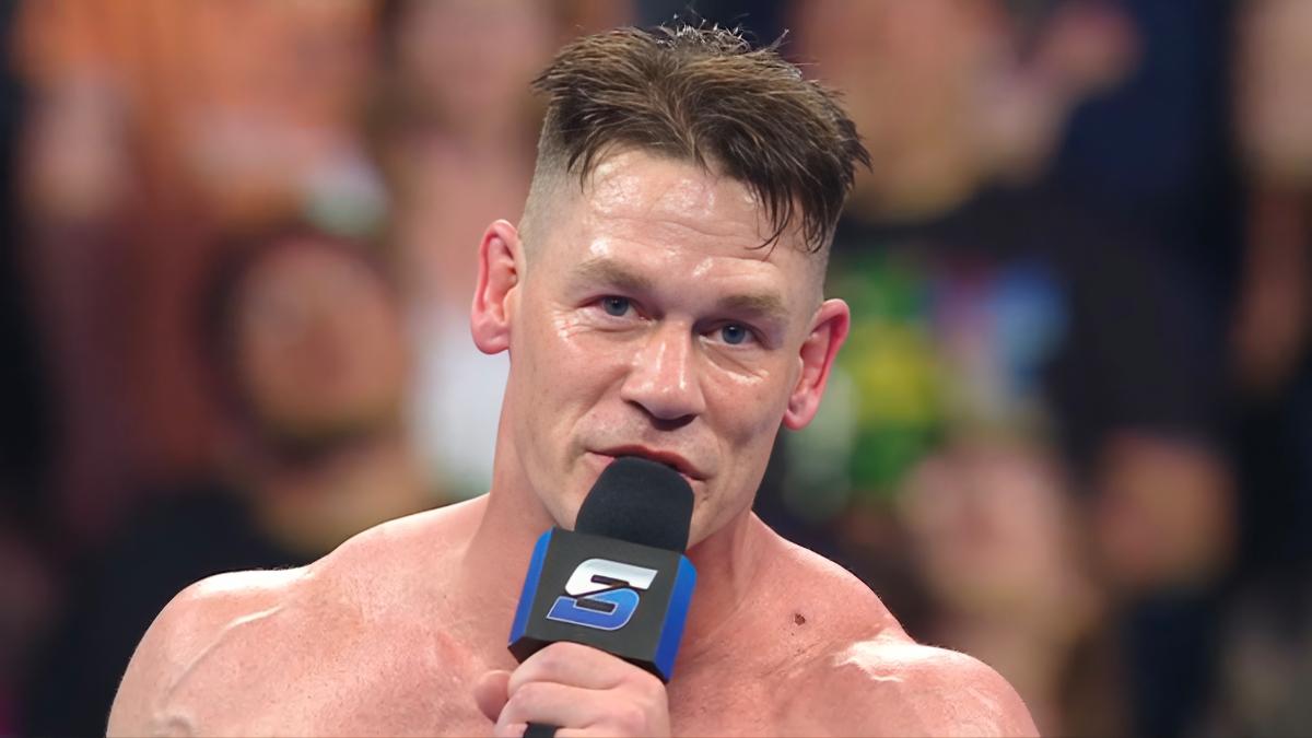 John Cena while sweaty cutting a promo holding a SmackDown microphone in June 2025