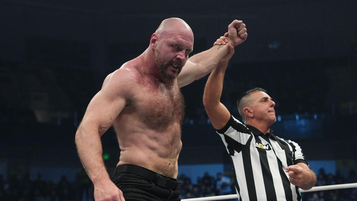 Jon Moxley with his arm raised by Paul Turner