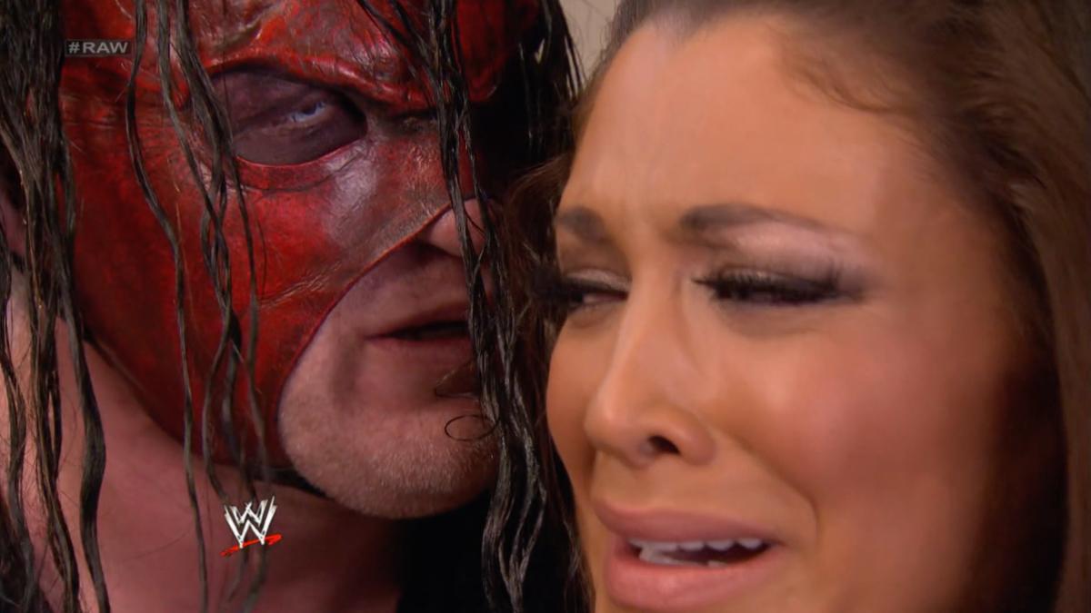 Kane staring at Eve Torres as she tries look away, terrified. 