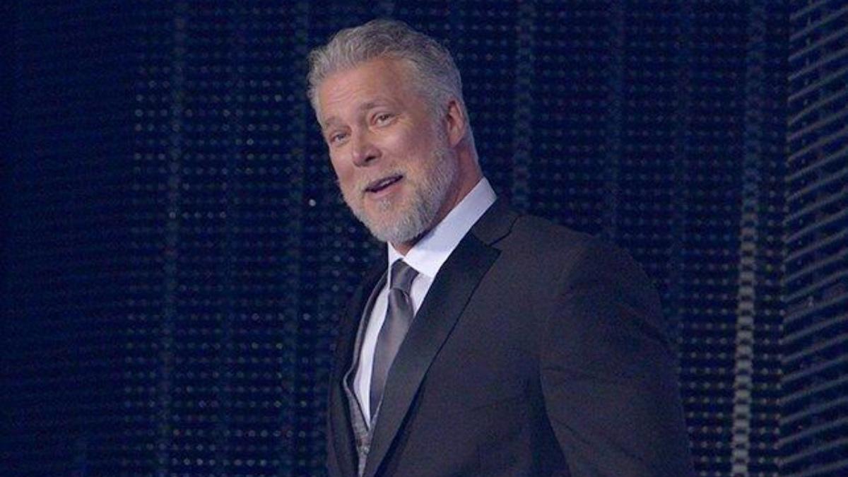 Kevin Nash smiling in a suit