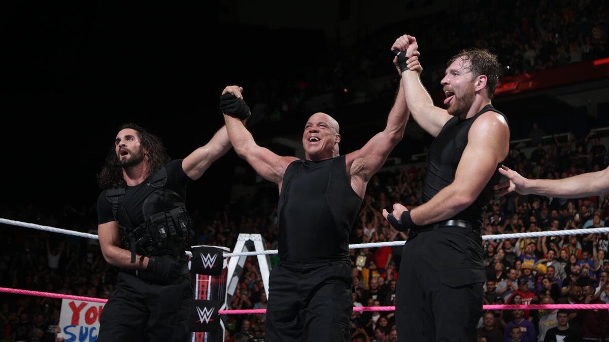 Kurt Angle celebrating with Dean Ambrose and Seth Rollins as part of The Shield at WWE TLC 2017