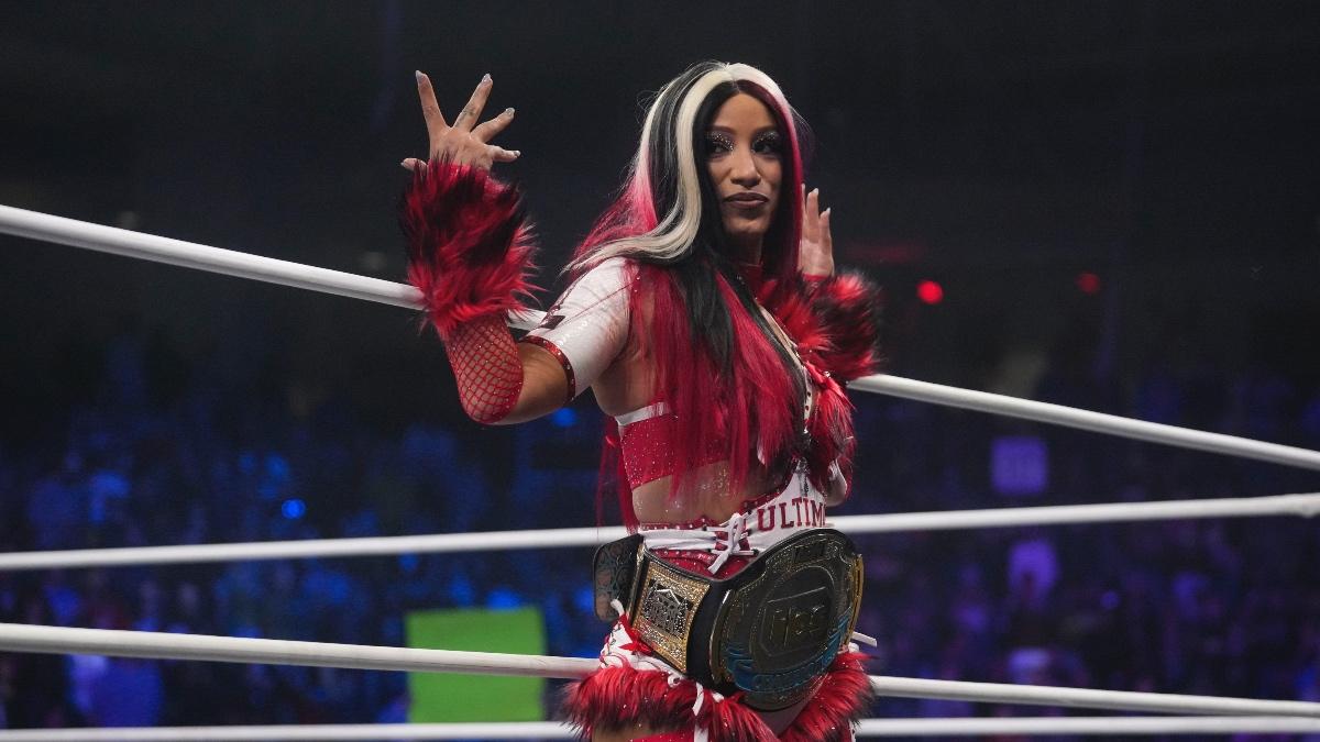 Mercedes Mone standing on the ring apron with the AEW TBS Title around her waist
