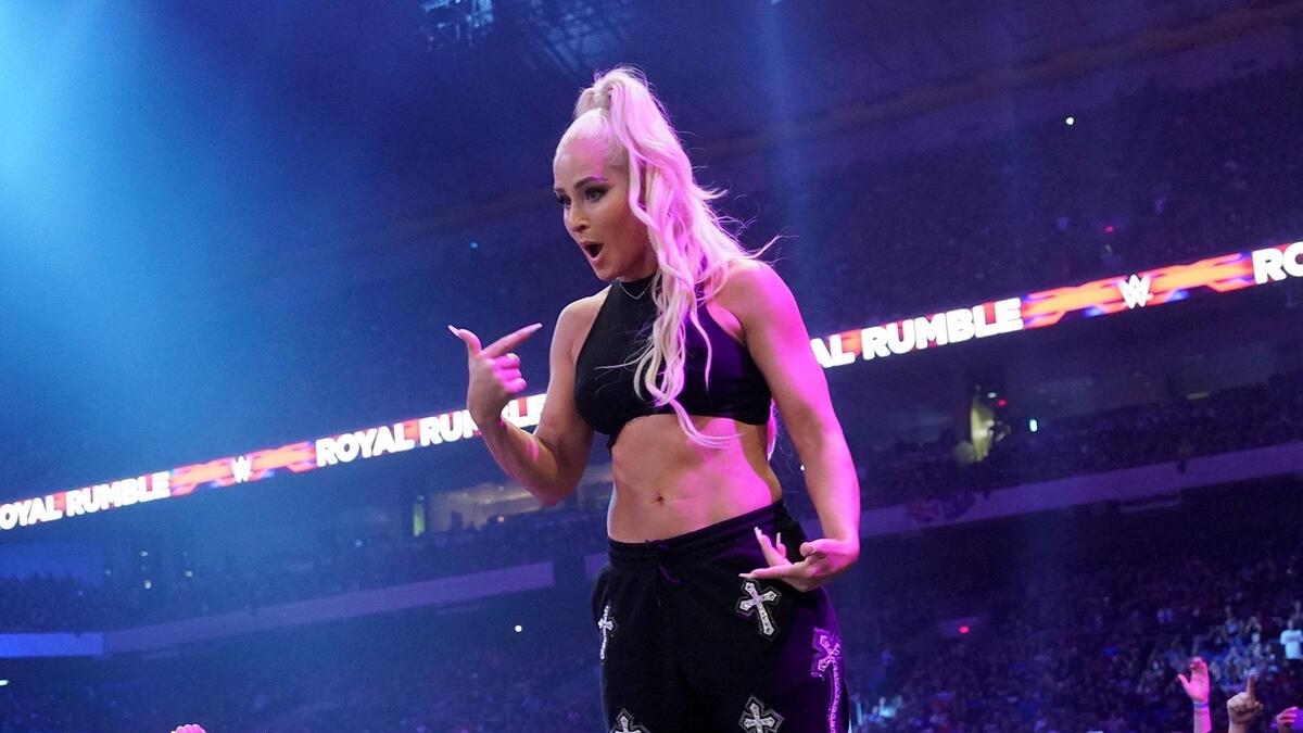 Michelle McCool stands on the ringside barrier after being revealed as a surprise entrant in the 2023 Women's Royal Rumble match