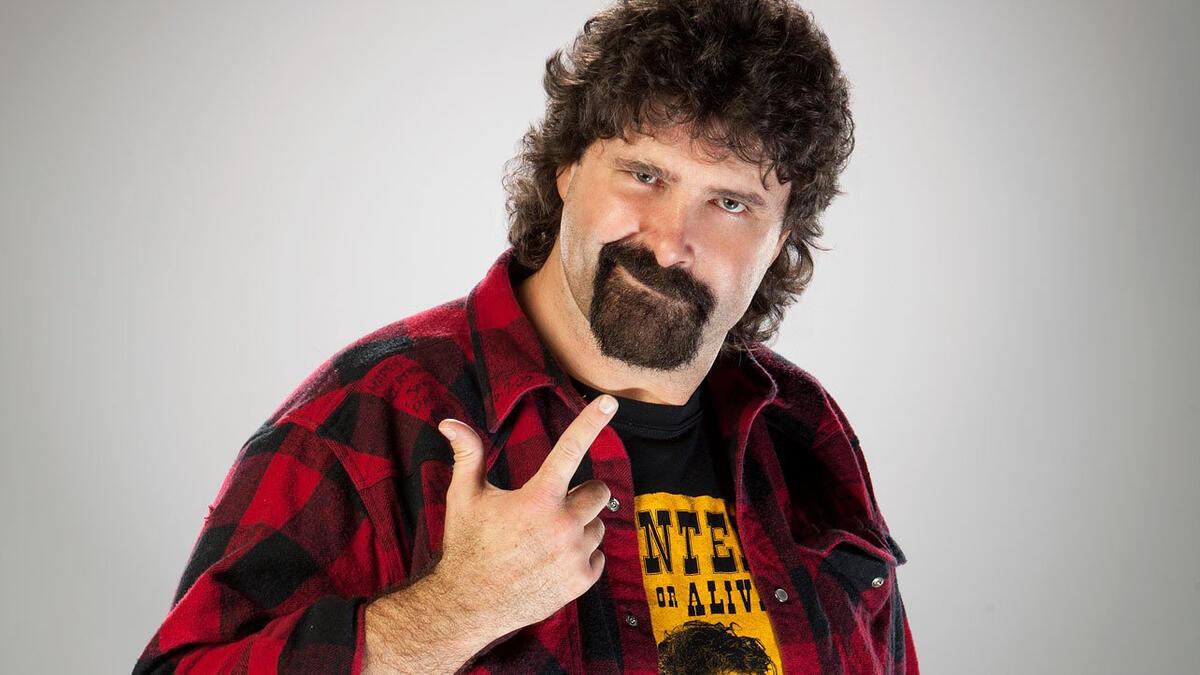 Mick Foley does his 'bang bang' pose for a WWE studio shot circa 2011