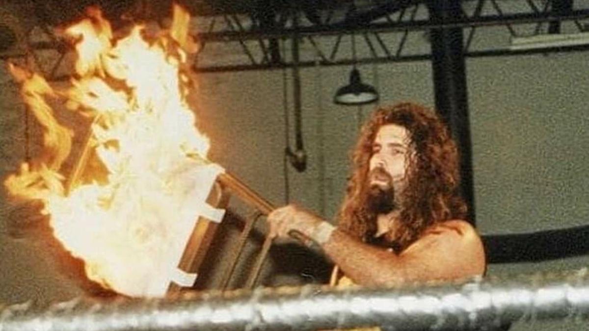 Mick Foley wielding a flaming steel chair on October 28, 1995
