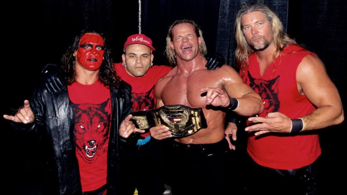 Sting, Konnan, and Kevin Nash flank NWO Wolfpac partner Lex Luger who is holding the WCW US Championship belt.