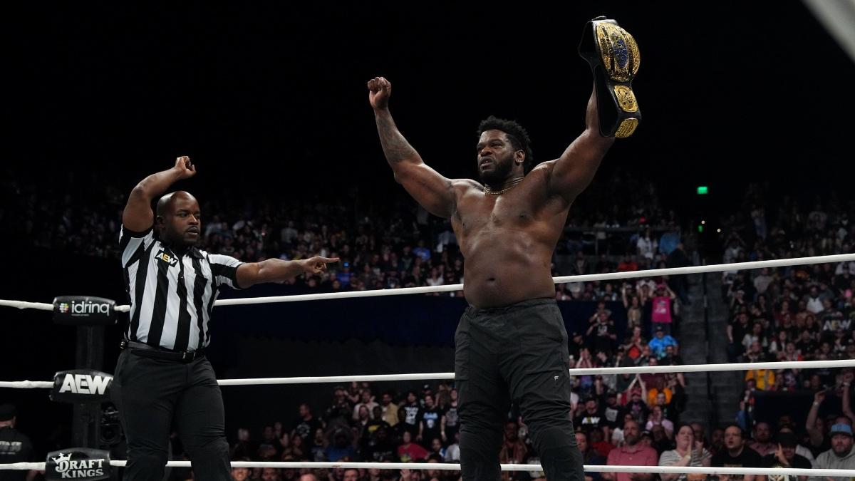 Powerhouse Hobbs topless holding up the AEW World Trios Title in June 2025