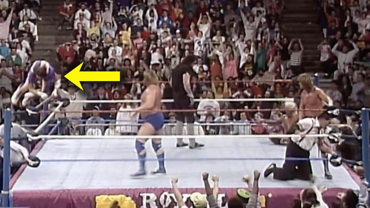 A screenshot of the 1992 Royal Rumble with a yellow arrow pointing to Randy Savage jumping over the top rope