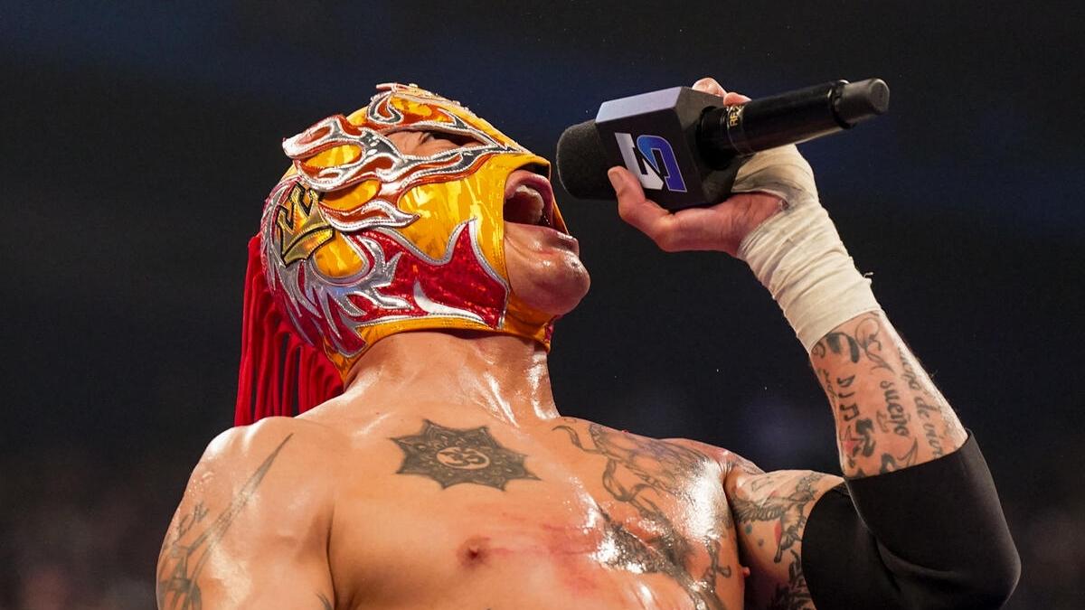 Rey Fenix holds the microphone while cutting a promo following his debut victory over Nathan Frazier on SmackDown