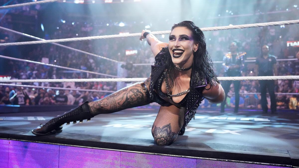 Rhea Ripley on the apron on WWE Raw smiling at the camera