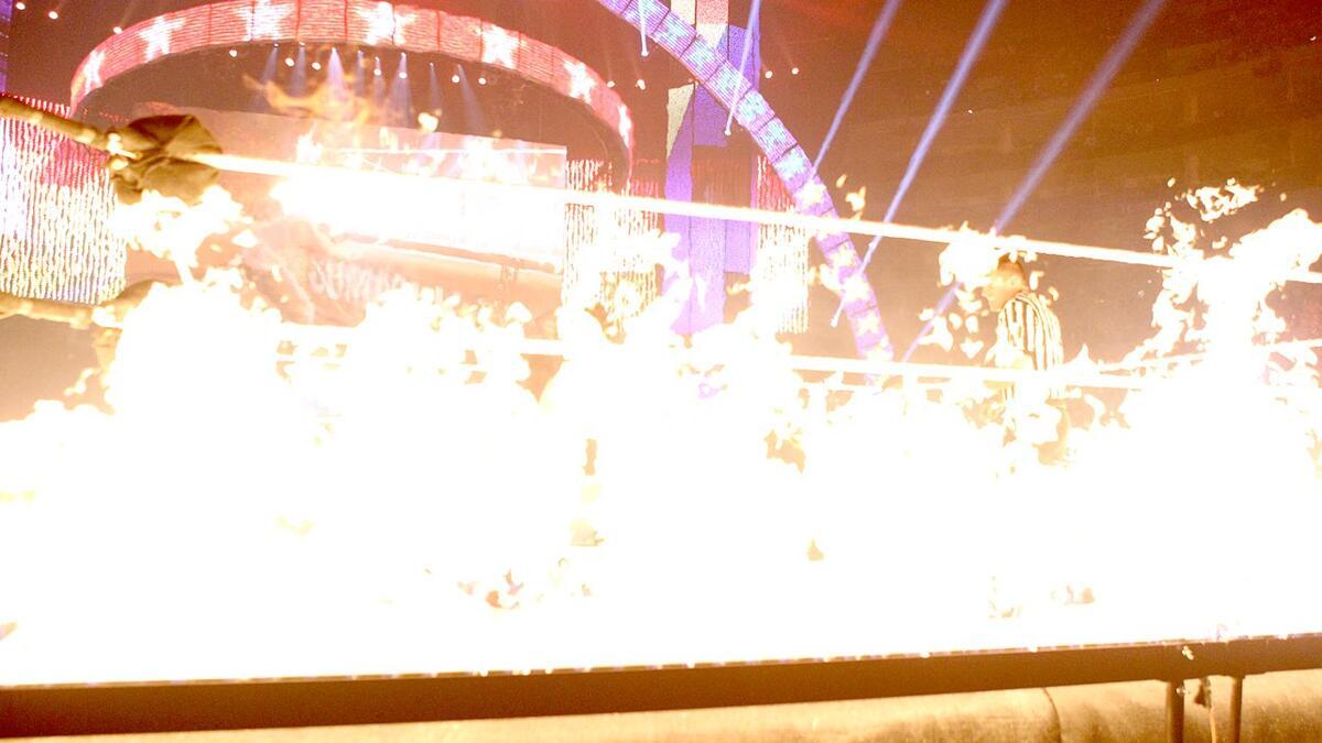 Flames surround the ring during the Ring of Fire match at WWE SummerSlam 2013
