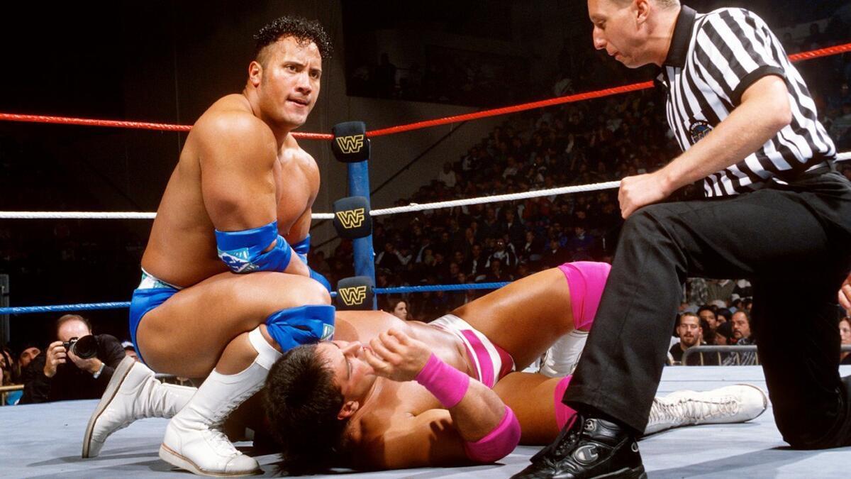 Rocky Maivia on WWE Raw kneeling down